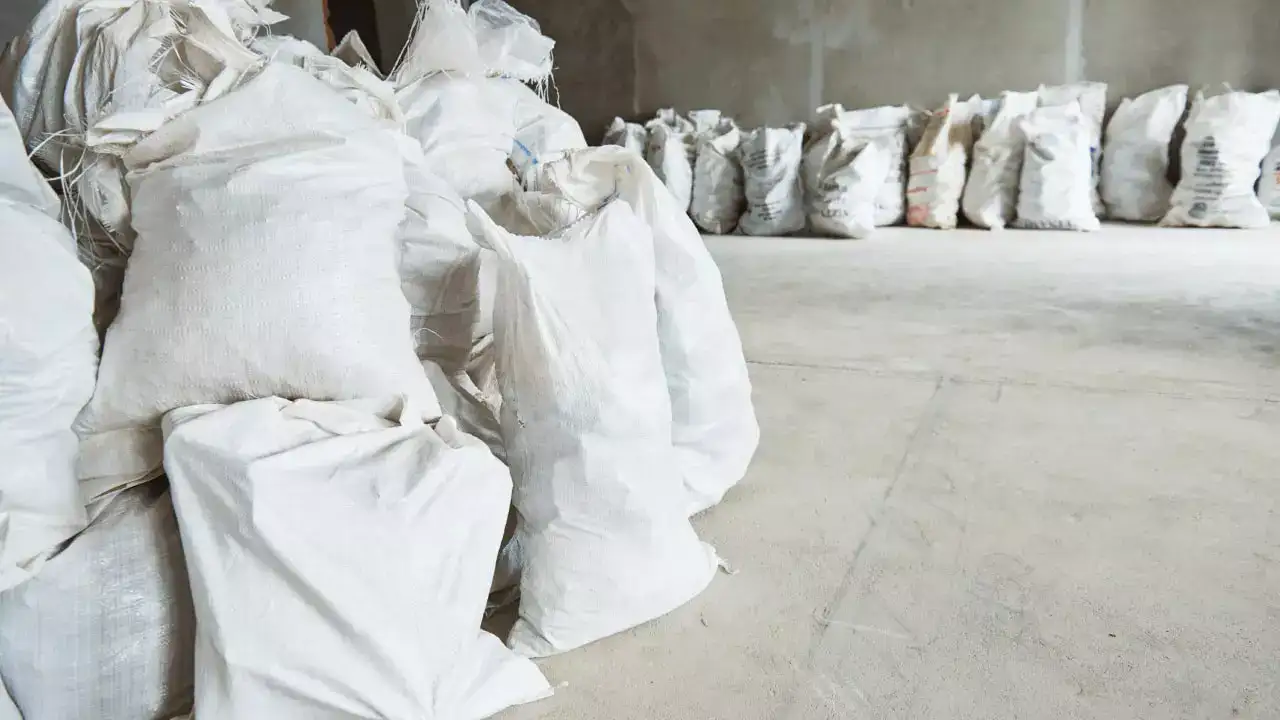 Multiple builder’s waste sacks stacked in a cleared interior space ready for collection in Hastings